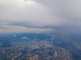 Spring rain over Kiev. There are black thunderclouds in the sky, dark rain falls on the city. Aerial drone view.
