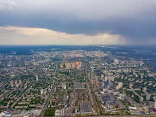 Spring rain over Kiev. There are black thunderclouds in the sky, dark rain falls on the city. Aerial drone view.