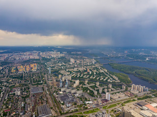 Spring rain over Kiev. There are black thunderclouds in the sky, dark rain falls on the city. Aerial drone view.