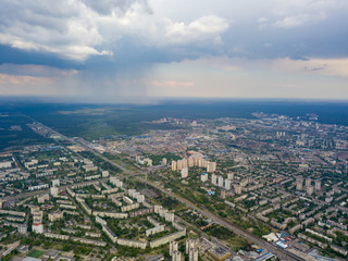 Spring rain over Kiev. There are black thunderclouds in the sky, rain is falling on the city. Aerial drone view.