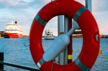  A small ferry passing a larger passenger ro-ro car ferry on its way to port.