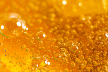 Liquid yellow paste for sugaring close-up. Depilation and hair removal concept. Macro photo.