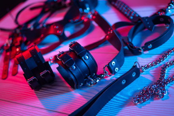 Set of erotic toys for BDSM. The game of sexual slavery with a whip, gag and leather blindfold....