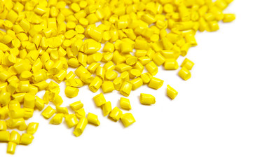 Yellow plastic polymer granules isolated on white 