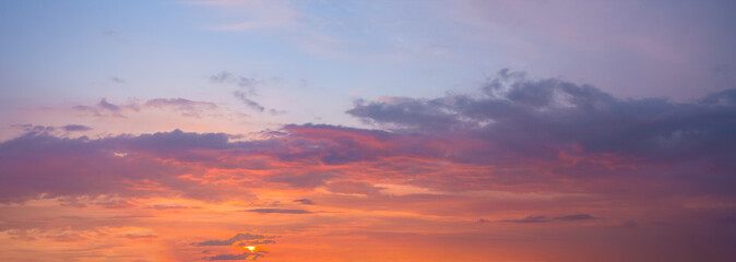 panorama of a blue-pink sunset with clouds of pink hues. sunset on the horizon. photo for the banner. space for text.