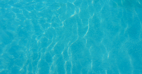 Fototapeta na wymiar Blue water wave texture in swimming pool