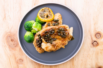 Italian food Lemon chicken Piccata  with Brussels Sprouts