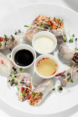 asian fresh vegetable vegan spring rolls with sauces in vietnam