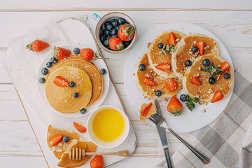 Pancake breakfast concept with honey and nuts berries.