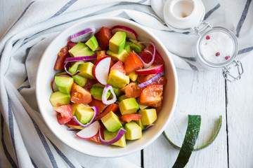 Vegetable salad with avocado, tomatoes and radish. Healthy food concept
