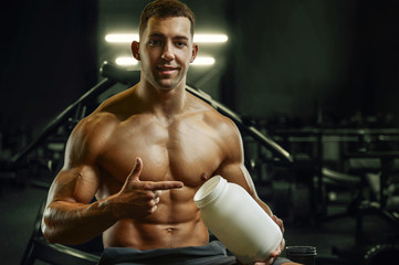 Fototapeta na wymiar Bodybuilder protein powder after fitness workout