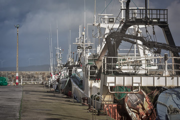 Fishing trawlers standing in the harbour. Concept of work. Galicia, Spain.