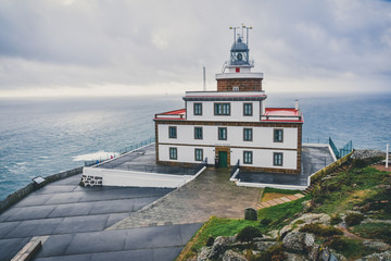 Fototapeta na wymiar View from above Finisterre Lighthouse, on the route of the Camino de Santiago. On a cloudy day, with the sea in the background. Galicia, Spain