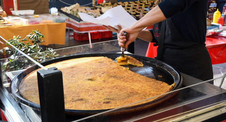 Nice, France, 25th of February 2020: Farinata or Cecina or Torta di ceci thin unleavened pancake