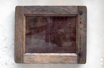 Wooden frame for glass photonegatives on the table, old paper background.