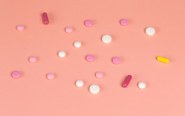 Different medications. Various pills and capsules. One-color backdrop.