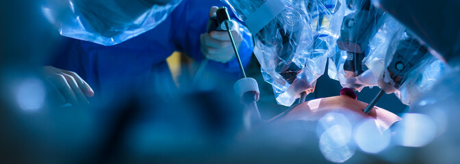 Surgery in a modern hospital being performed by a team of professionals (shallow DOF, color toned...