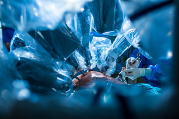 Fototapeta na wymiar Surgery in a modern hospital being performed by a team of professionals (shallow DOF, color toned image)