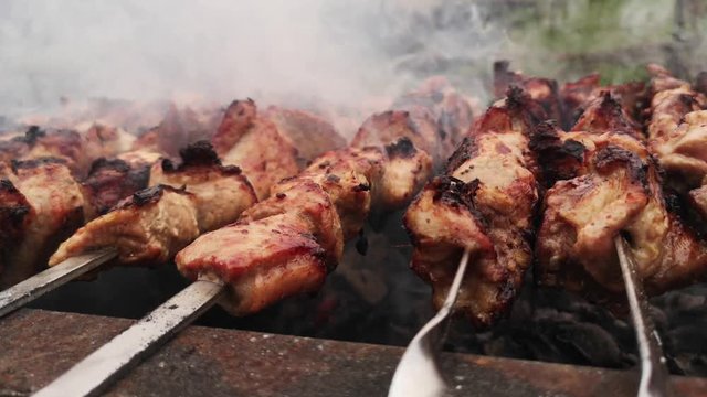 The meat on skewers is fried on the grill.