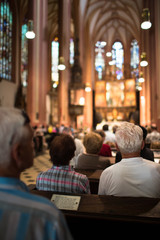 People in a church during a mass - obrazy, fototapety, plakaty