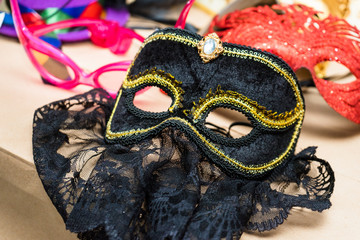 a black mask with veil for masquerade