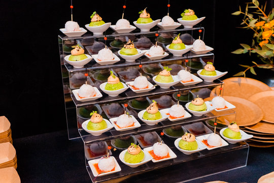 a stand serving furshet with gourmet food at an anniversary party