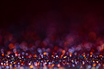 Decoration bokeh glitters background, abstract shiny backdrop with circles,modern design wallpaper with sparkling glimmers. Purple, red, golden and black backdrop glittering sparks with glow effect
