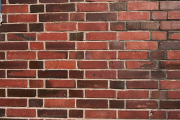 Fototapeta premium Texture of a mixed red brick wall