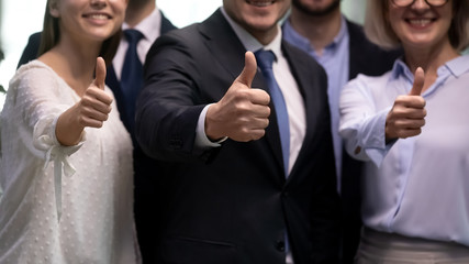 Diverse businesspeople stand in row showing thumbs up close up. Gesture of best recommendations, group of people advise company services, professionals team help you, carrier opportunity offer concept