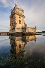 Belem Tower at sunset reflected in teh water, Lisbon, Portugal