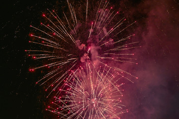 Obraz premium Red firework with smoke over the black sky. Low key exposure.