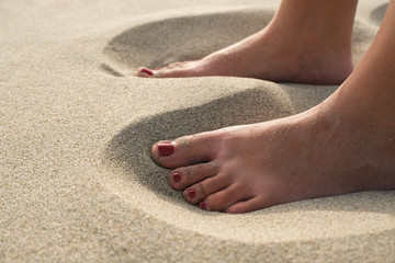 Closeup of Barefoot Woman girl Standing on Golden Sandy Beach in Sunny sunset light,freedom cilento