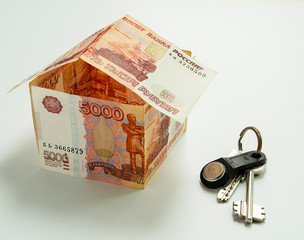 Banknotes Russian rubles, folded in the form of a house and house keys.