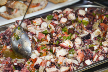 Octopus salad with lemon or salad de poulpe on white dish french nicoise food