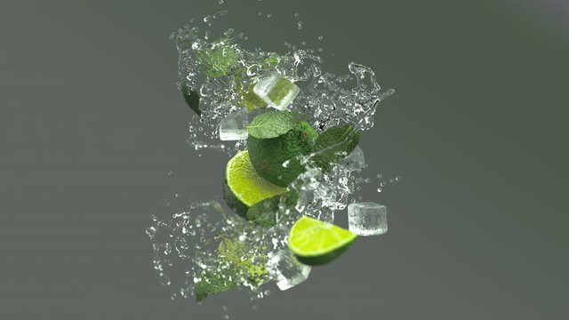 Mojito cocktail with splashing liquid and ice cubes. Fresh limes and mint leaves