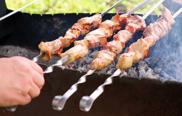 Cooking barbecue meat on charcoal. A hot dish of lamb, pork, turkey, chicken. Hot coals for barbecue and grill. Rest at nature