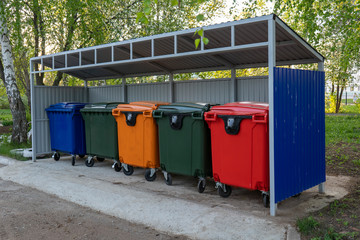 Fototapeta na wymiar Different color plastic street containers for garbage collection