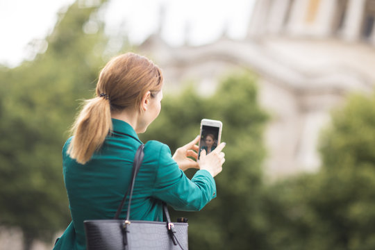 young woman taking a selfie on her phone