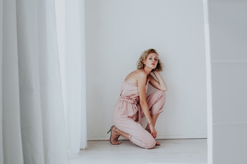 Portrait of a beautiful woman blonde in a fashionable jumpsuit
