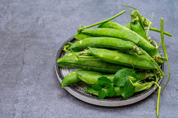 New harvest of ripe green peas legumes