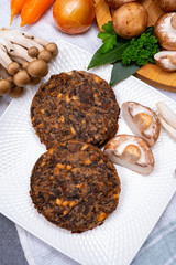 Tasty vegetarian food, burgers with champignons mushrooms, buna shimeji, carrot and onion