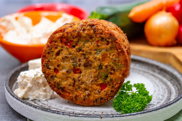 Tasty vegetarian food, burgers with Greek feta cheese, sweet red paprika, green olives and zucchini