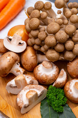 Fresh ingredients for tasty vegetarian mushrooms soup, brown champignons, buna shimeji, carrots