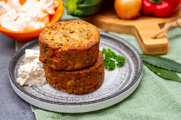Tasty vegetarian food, burgers with Greek feta cheese, sweet red paprika, green olives and zucchini