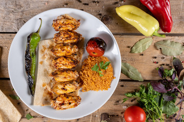 Kebabs - grilled meat and vegetables. Grilled chicken breast. Fried chicken fillet and fresh vegetable salad of tomatoes, cucumbers and arugula leaves.
Grilled chicken legs with spices and garlic.