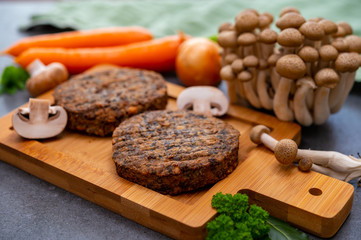 Tasty vegetarian food, burgers with champignons mushrooms, buna shimeji, carrot and onion