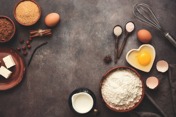 Ingredients for baking - products, spices, kitchen tools on a dark rustic background, corner frame....
