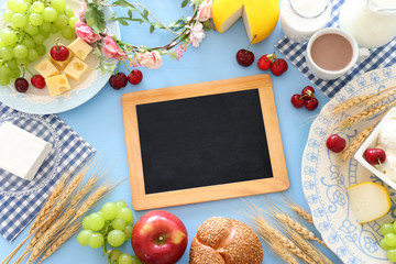 Top view photo of dairy products over pastel blue background. Symbols of jewish holiday - Shavuot