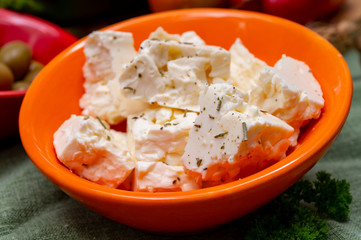 Ingredient for traditional Greek salad, fresh salted feta cheese with herbs