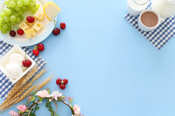 Top view photo of dairy products over pastel blue background. Symbols of jewish holiday - Shavuot